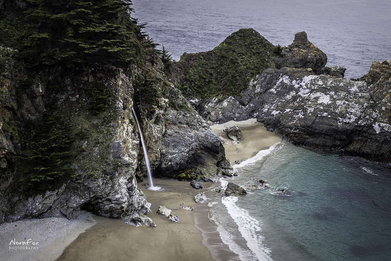 Aerial View Of McWay Falls / Flickr / Norm Fox
Link: https://www.flickr.com/photos/normfox/40364974055/in/photolist-24uV3ux-2nvz3wu-2hQCXJj-bgsPBa-2oePnVo-2idWkT9-2iNe6zx-2nrDbPk-RULJqe-2nDFUCX-HTtKET-eevFL1-FMpoVV-Gy49FE-85JN9Z-og2mBZ-3KCfKw-3KC631-3KxUdg-hfg1Wb-whupgo-Stk6e2-QgAWdN-GB1DL9-2nZDpno-hhvHTU-EygdCS-2nVqkSx-P2Fh9N-FKnSm6-bgsPek-EX1jqq-29z1vSm-2ouuXmQ-f3vgdM-K8TdQC-GgnyAe-GGuH2h-7yTqVU-G1mUqT-Mr4LMp-2hSNJCN-KY3nhn-PpeZuo-KAKJxr-2nguoZ8-2nGYYqP-2ojf5hk-wVNZcX-ADBpTg
