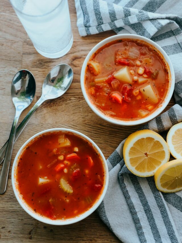 soup in white ceramic bowl beside sliced lemon on white ceramic plate